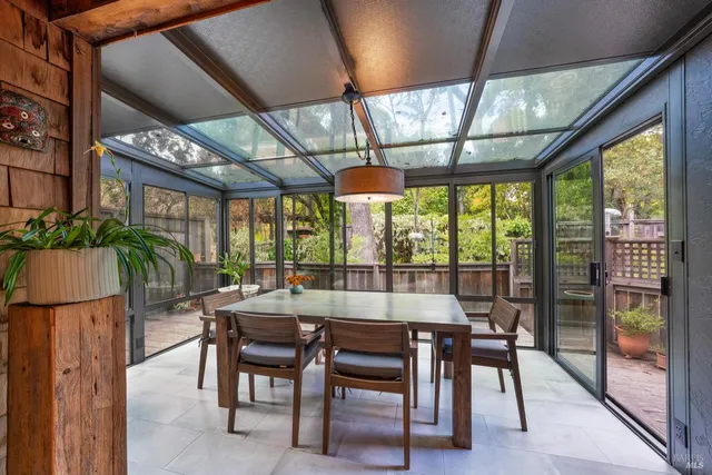 a dining room with furniture a chandelier and wooden floor