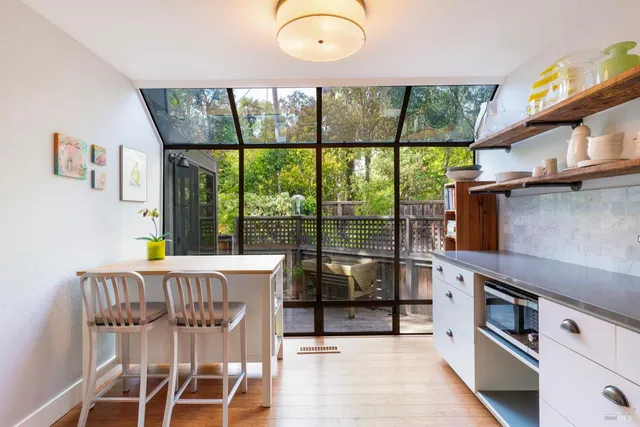 a kitchen with a table chairs and a stove