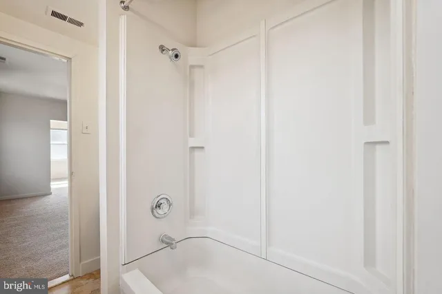 a bathroom with a glass shower door