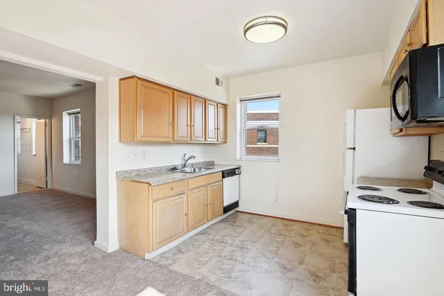 a kitchen with stainless steel appliances granite countertop a stove and a sink