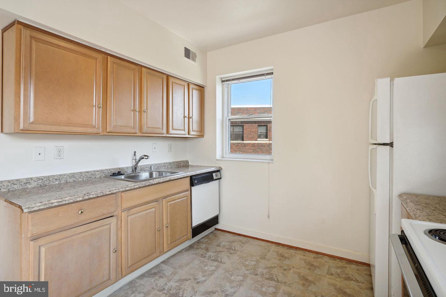 55 M Street Northwest, Unit 406 Washington, DC 20001 - Photo 9 of 23 a kitchen with stainless steel appliances granite countertop a sink stove and refrigerator