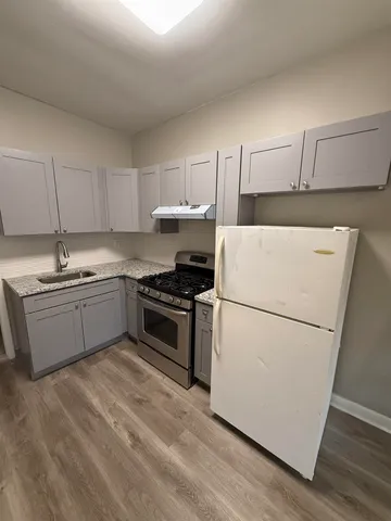 a kitchen with a white cabinets and white appliances