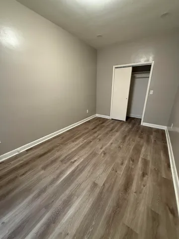 a view of an empty room and wooden floor