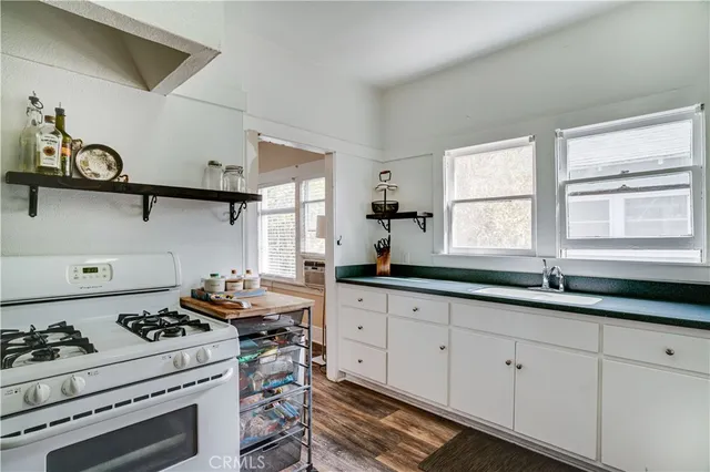a kitchen with white cabinets and appliances