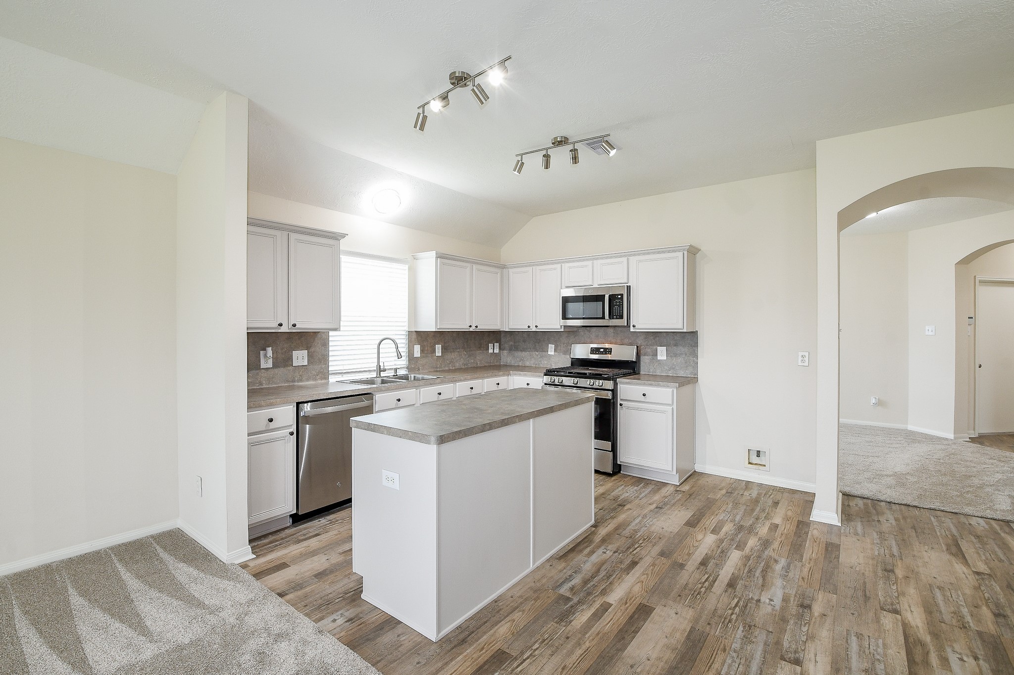 9203 Windy Spring Court Houston, TX 77089 - Photo 11 of 33 a kitchen with stainless steel appliances granite countertop a stove and a refrigerator