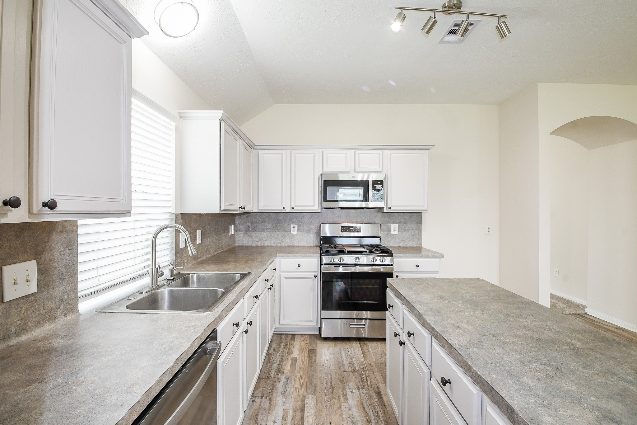 9203 Windy Spring Court Houston, TX 77089 - Photo 13 of 33 a kitchen with stainless steel appliances granite countertop a sink stove cabinets and refrigerator