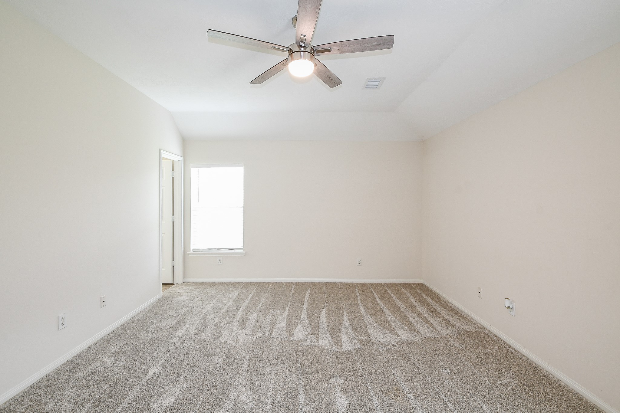 9203 Windy Spring Court Houston, TX 77089 - Photo 16 of 33 an empty room with a window and a ceiling fan