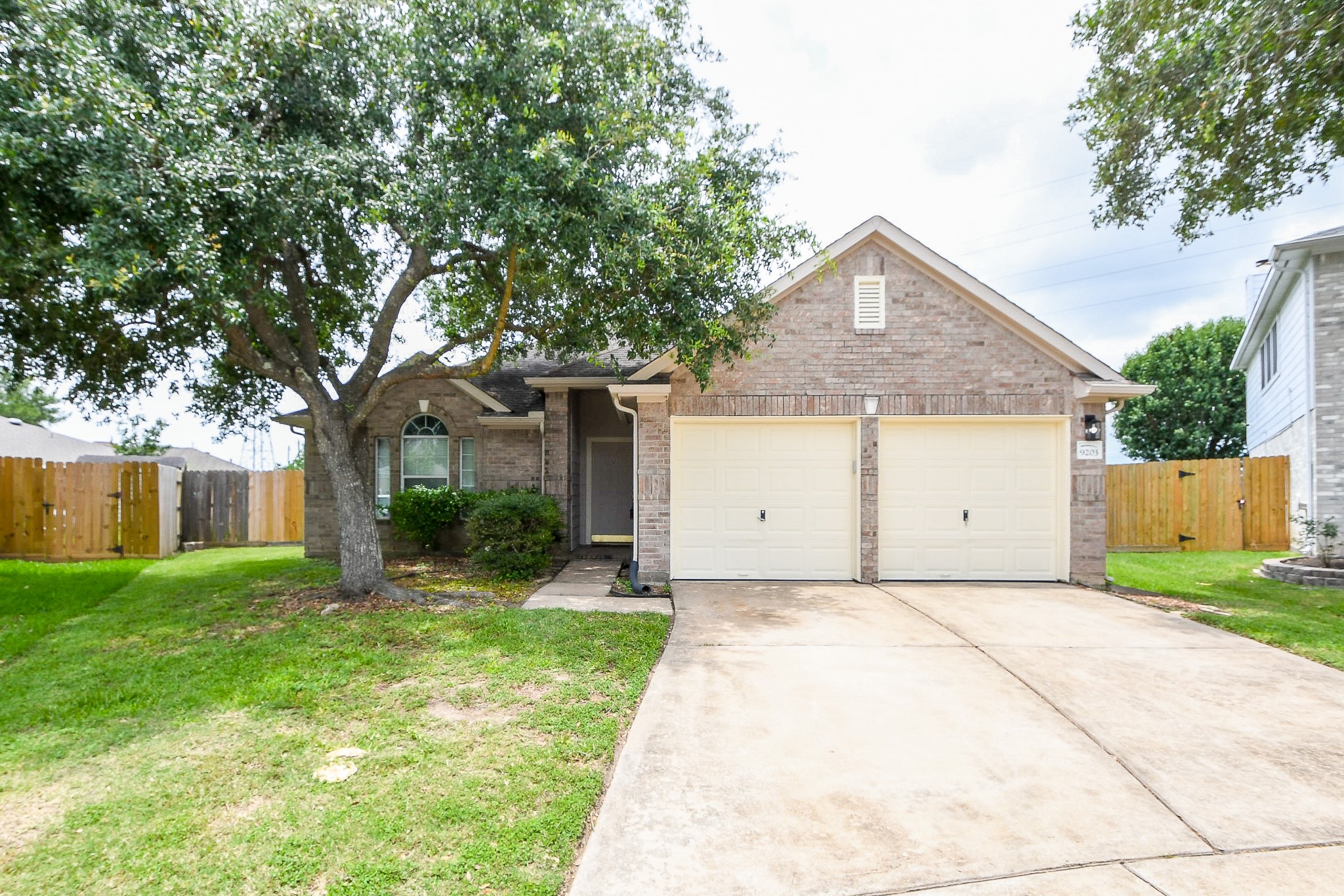 9203 Windy Spring Court Houston, TX 77089 - Photo 2 of 33 a front view of a house with a yard and garage