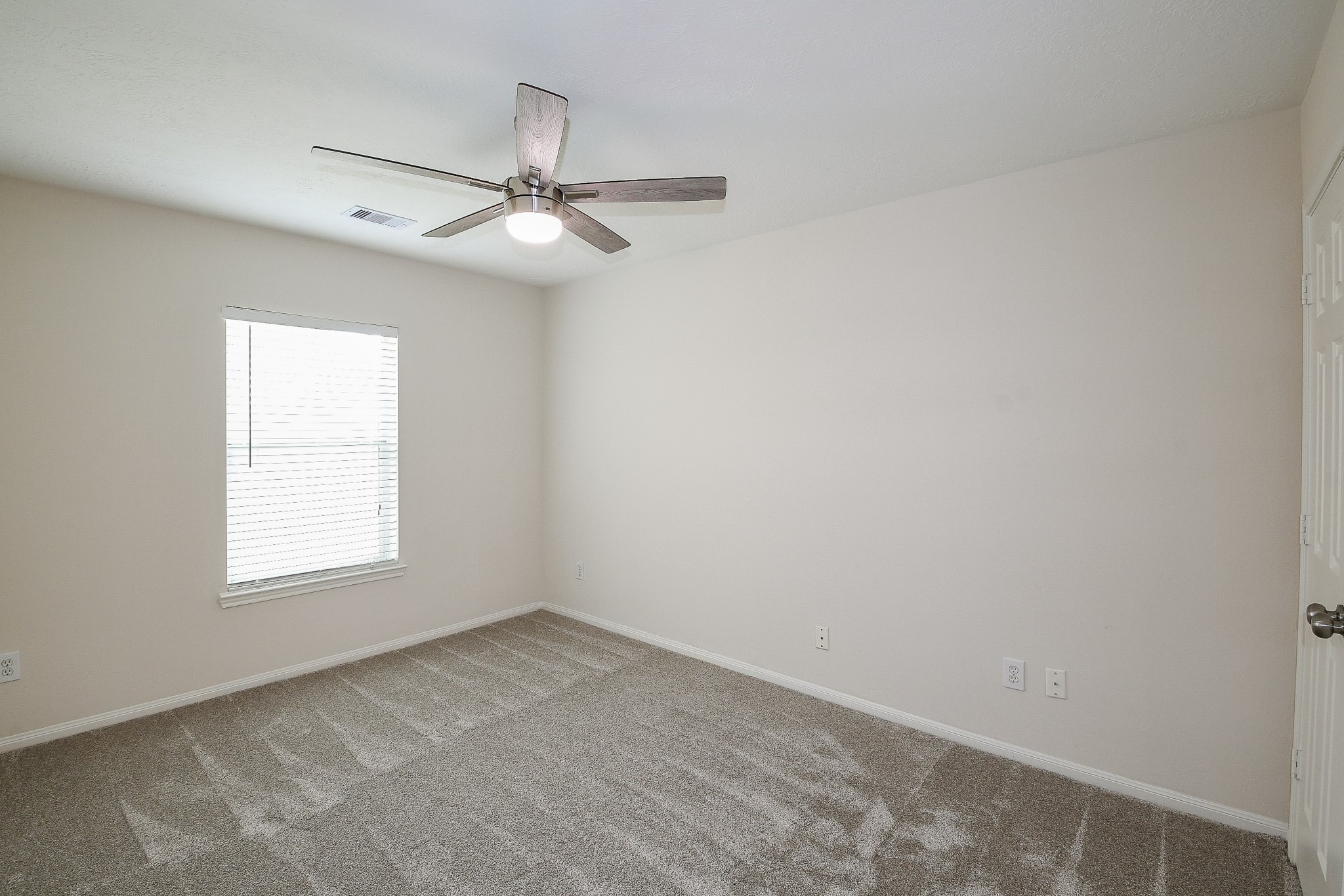 9203 Windy Spring Court Houston, TX 77089 - Photo 23 of 33 an empty room with a window and ceiling fan
