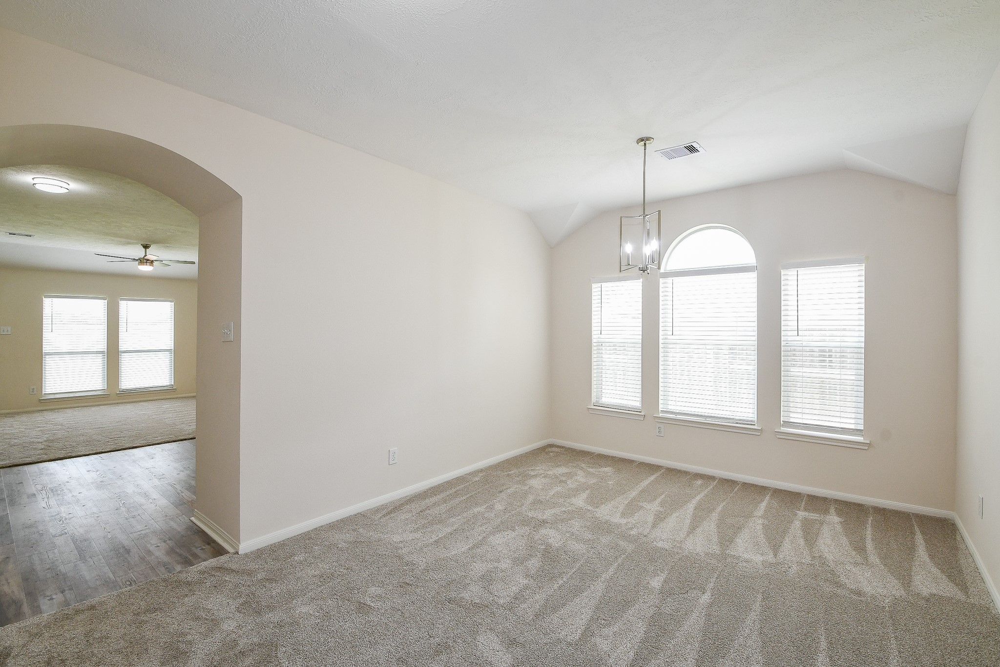 9203 Windy Spring Court Houston, TX 77089 - Photo 4 of 33 an empty room with chandelier fan and windows