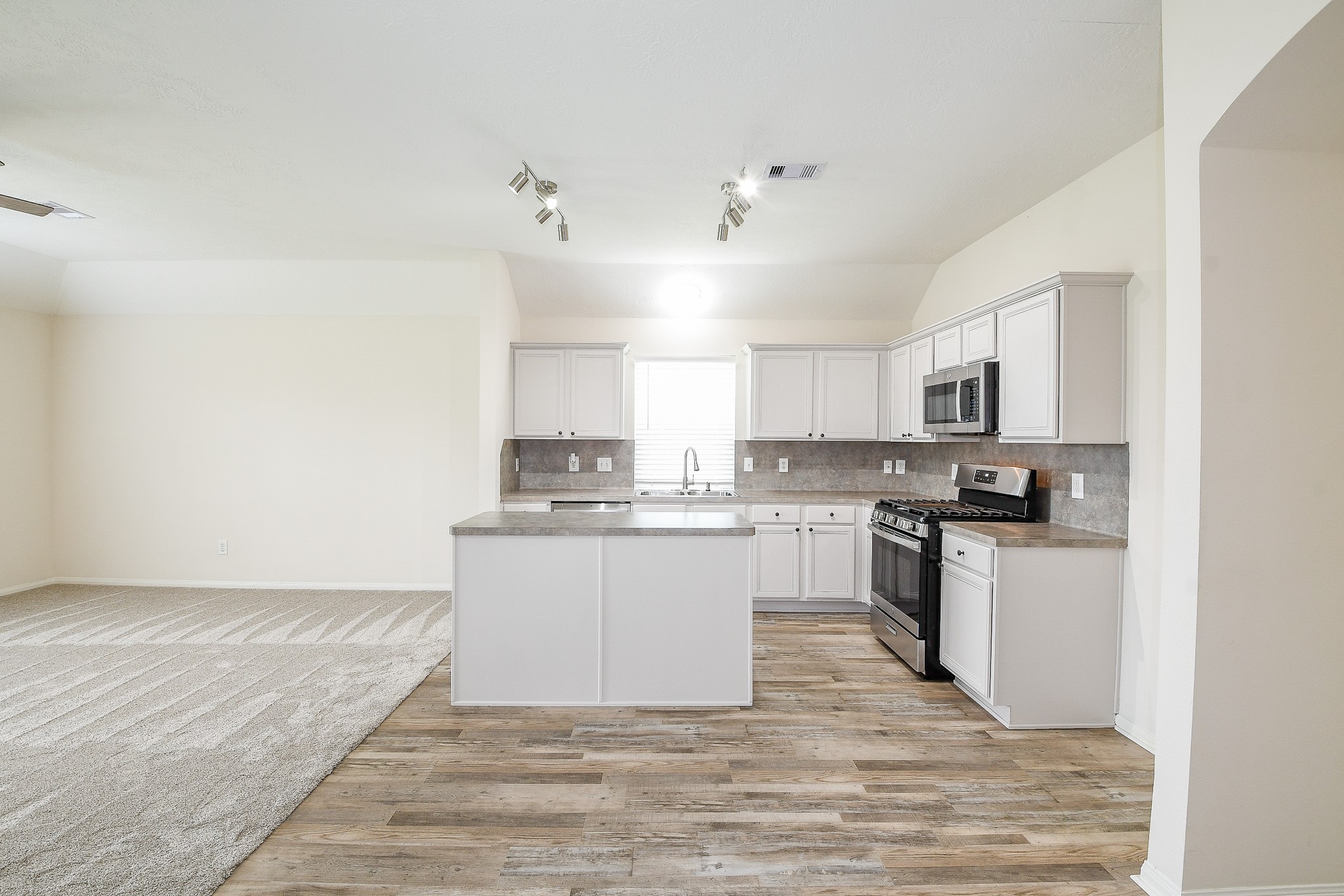9203 Windy Spring Court Houston, TX 77089 - Photo 9 of 33 a kitchen with granite countertop a refrigerator stove top oven and sink