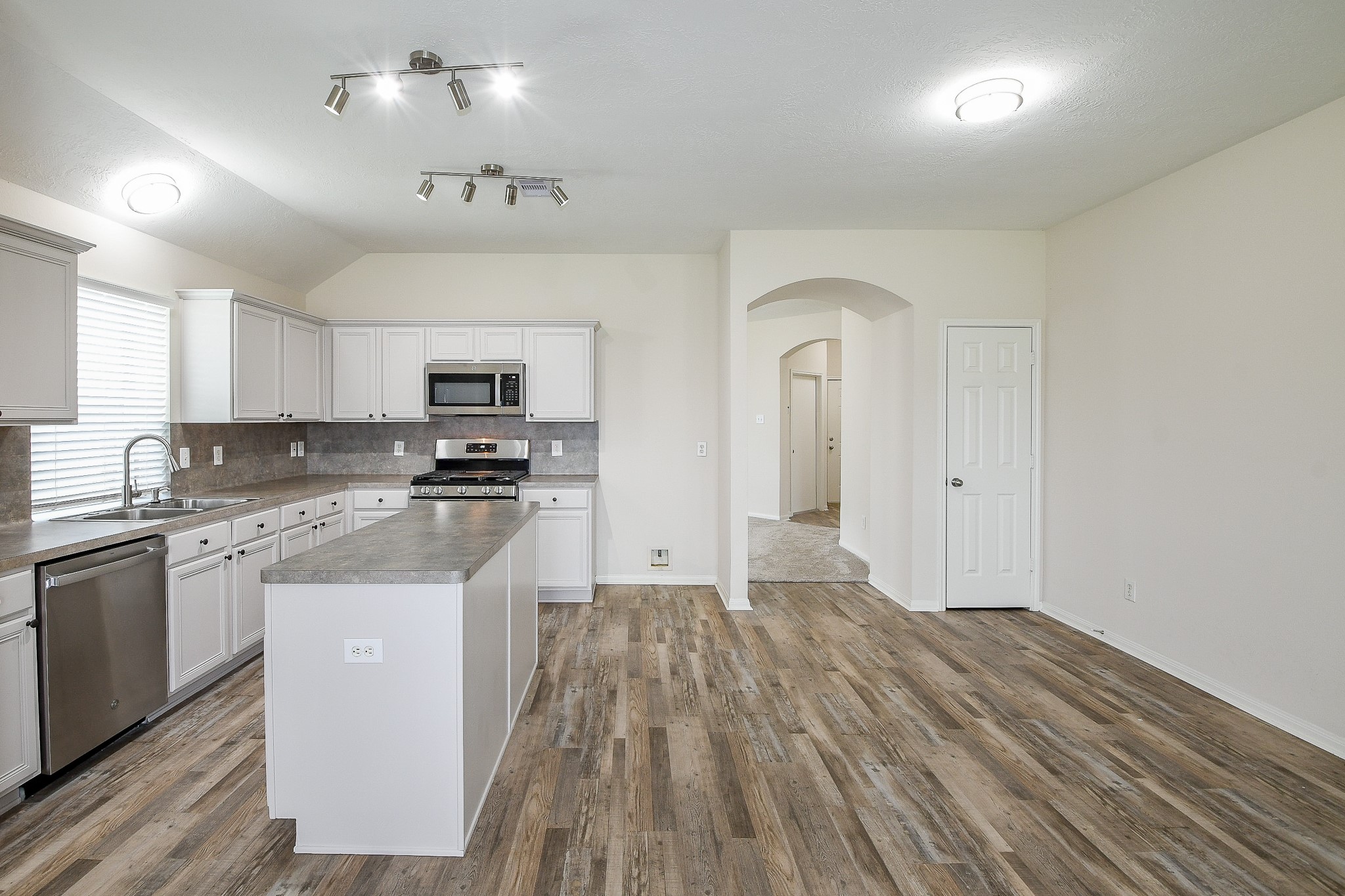 9203 Windy Spring Court Houston, TX 77089 - Photo 10 of 33 a kitchen with granite countertop a refrigerator stove top oven and sink