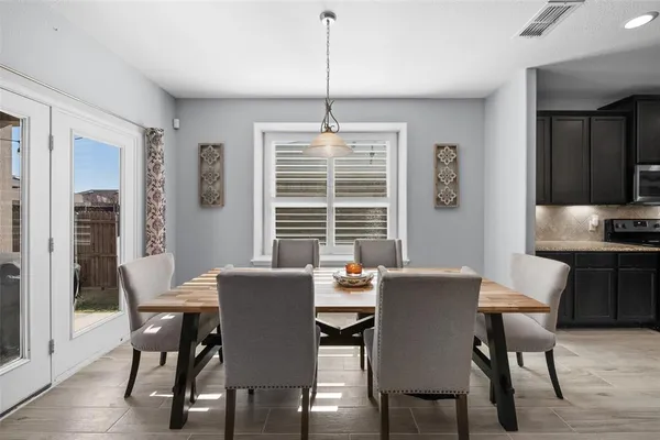 a kitchen with stainless steel appliances granite countertop a sink a stove and a wooden floors