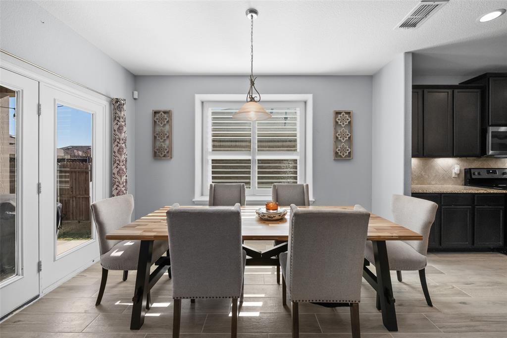 3709 Juniperio Street Denton, TX 76208 - Photo 12 of 31 a view of a dining room with furniture window and wooden floor
