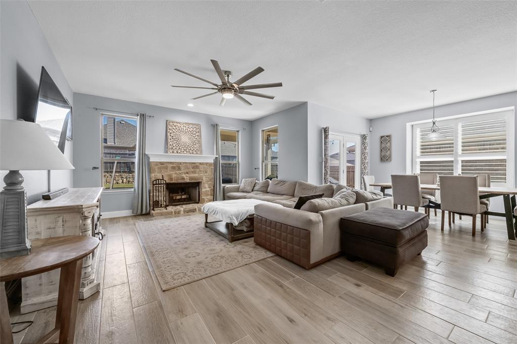 3709 Juniperio Street Denton, TX 76208 - Photo 13 of 31 a living room with furniture a fireplace and a large window