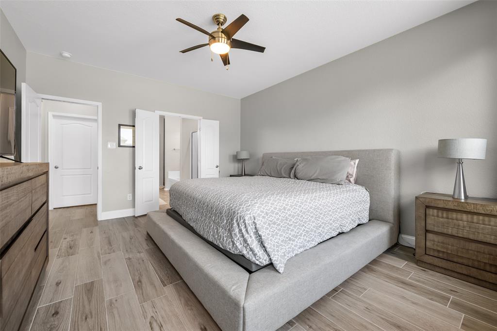 3709 Juniperio Street Denton, TX 76208 - Photo 17 of 31 a bedroom with a bed and a chandelier