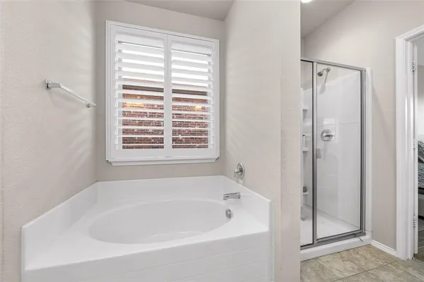 a spacious bathroom with a granite countertop sink a mirror and a