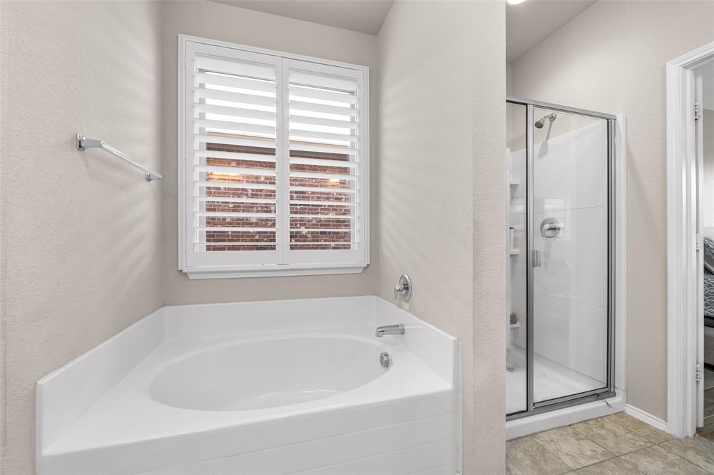 3709 Juniperio Street Denton, TX 76208 - Photo 19 of 31 a white bath tub sitting next to a window