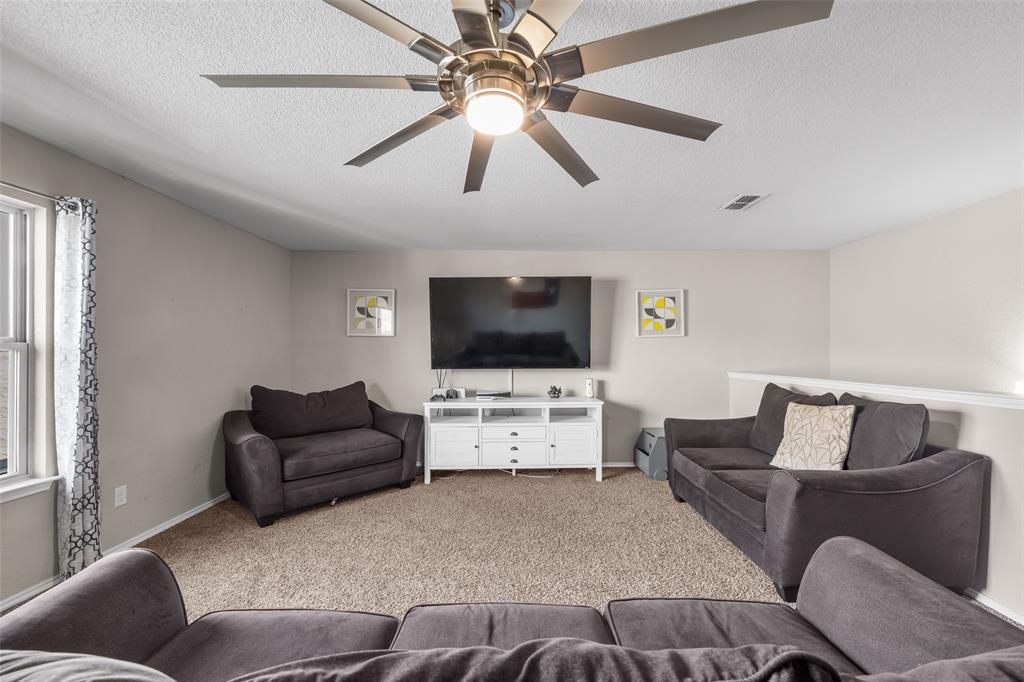 3709 Juniperio Street Denton, TX 76208 - Photo 21 of 31 a living room with furniture and a flat screen tv