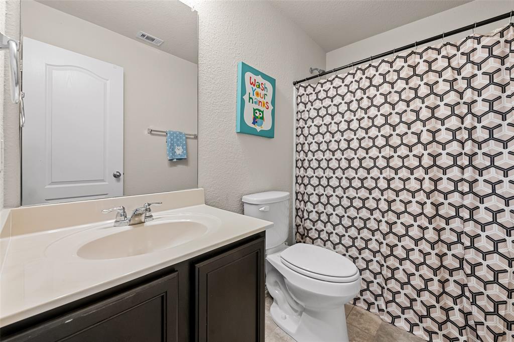 3709 Juniperio Street Denton, TX 76208 - Photo 26 of 31 a bathroom with a sink and a toilet