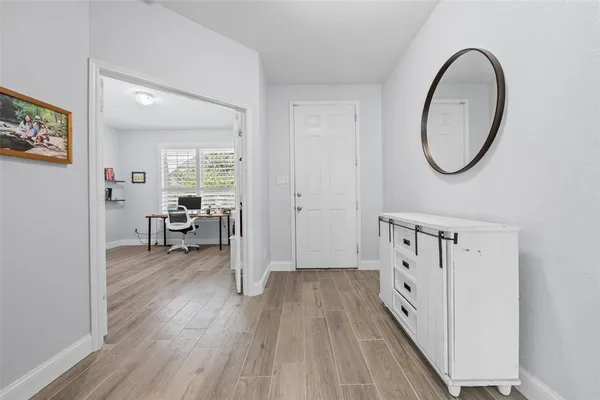 workspace with wooden floor mirror and windows
