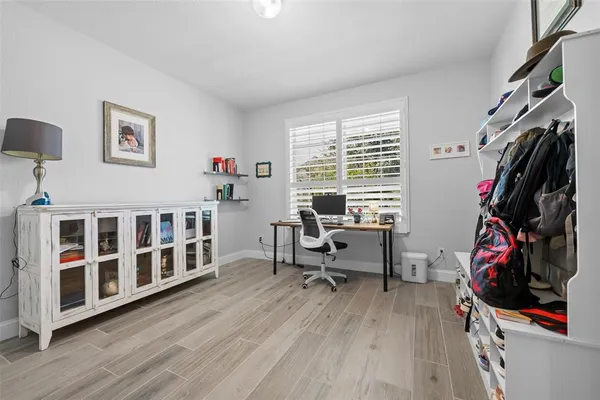 a view of a workspace with furniture and a window