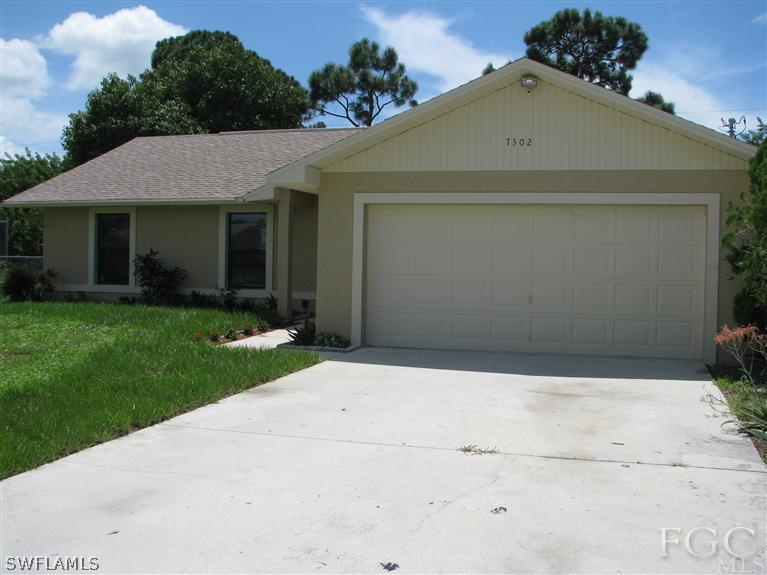 7302 Jonas Road Fort Myers, FL 33967 - Photo 1 of 10 a front view of a house with a yard