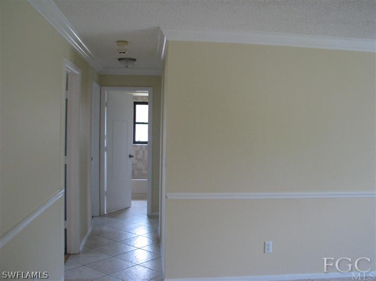 7302 Jonas Road Fort Myers, FL 33967 - Photo 8 of 10 a view of a hallway with wooden floor