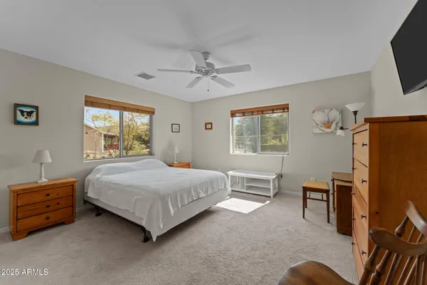 a bedroom with a bed dresser and a window