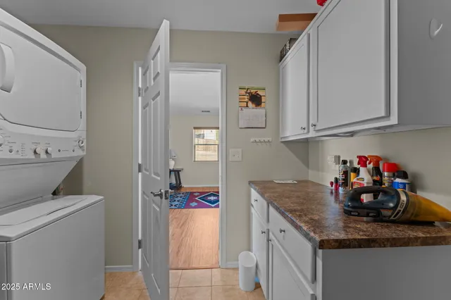 a utility room with fridge and vanity