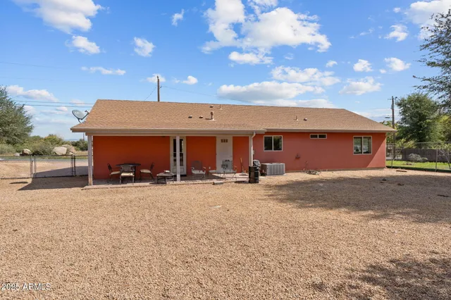a view of a house with a patio and a yard