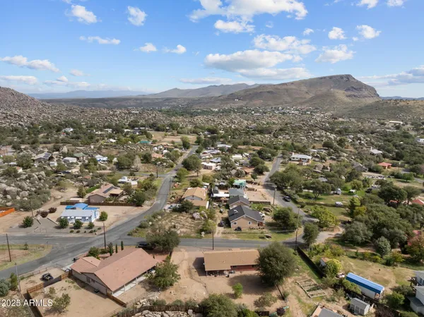 an aerial view of residential houses with outdoor space and trees