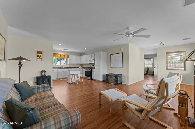 a living room with furniture and wooden floor