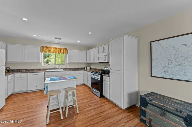 a kitchen with a refrigerator and a stove top oven