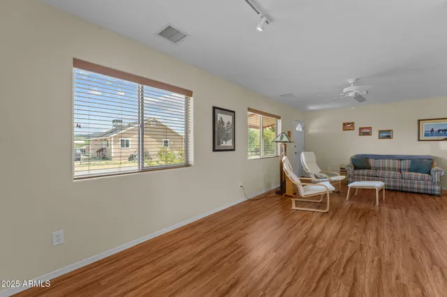 a living room with furniture and a wooden floor