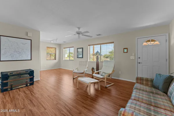 a living room with furniture and wooden floor