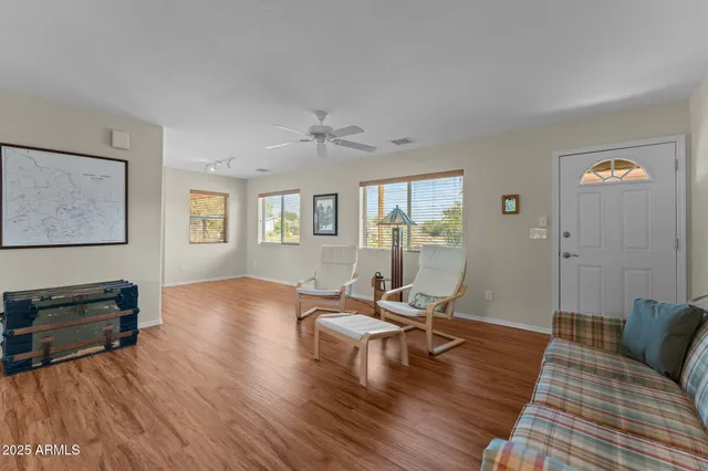 a living room with furniture and wooden floor