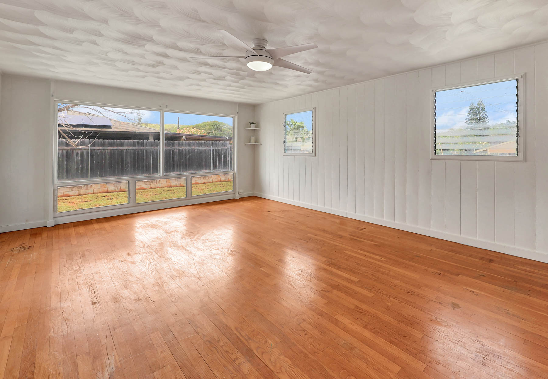 7954 B Kekaha Road Kekaha, HI 96752 - Photo 3 of 24 an empty room with wooden floor and windows