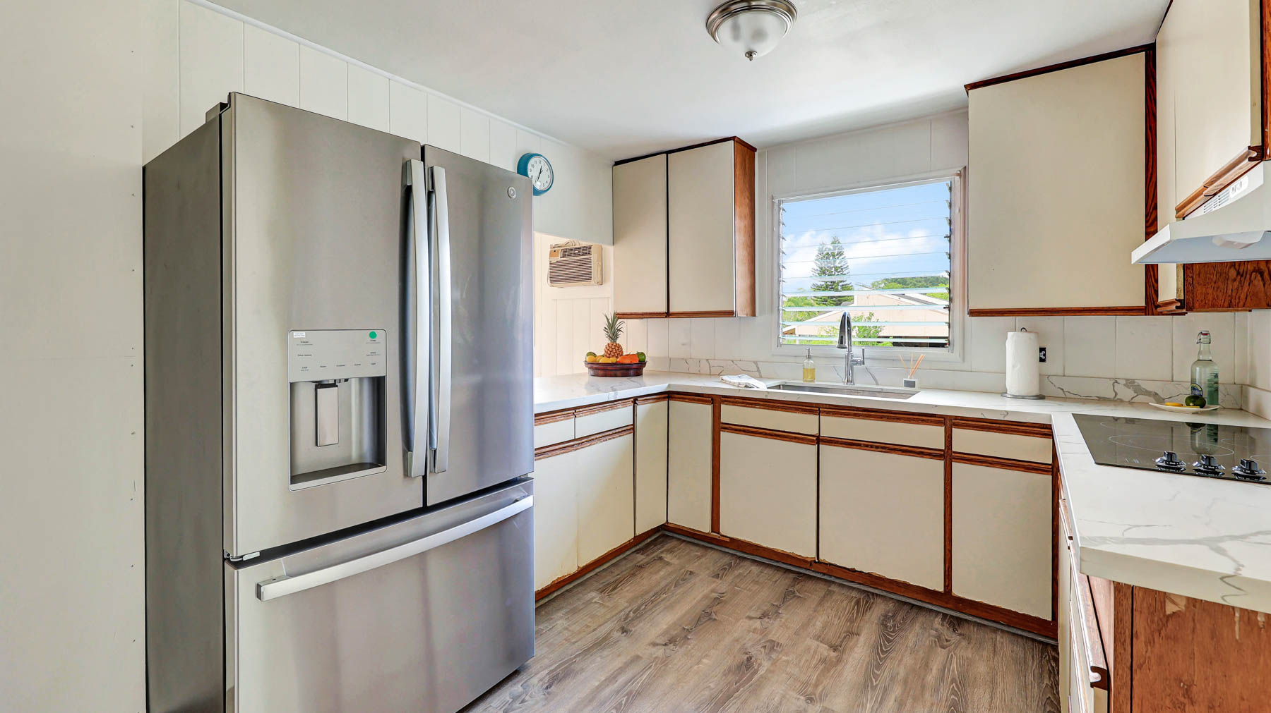 7954 B Kekaha Road Kekaha, HI 96752 - Photo 7 of 24 a kitchen with stainless steel appliances a refrigerator sink and cabinets