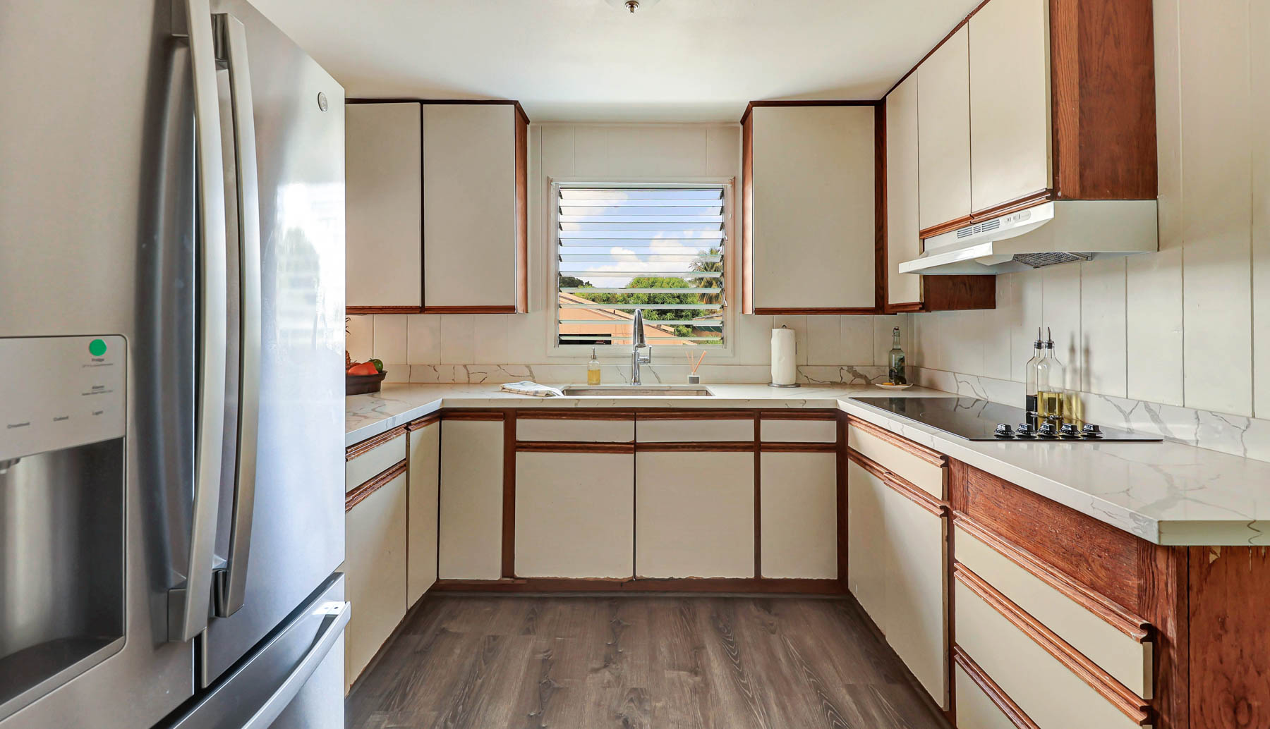 7954 B Kekaha Road Kekaha, HI 96752 - Photo 8 of 24 a kitchen with a sink cabinets stainless steel appliances and a window