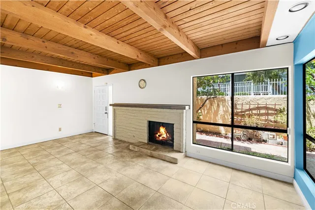 a view of empty room with a fireplace