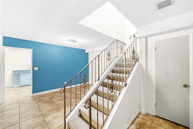 a view of staircase with railing and white walls