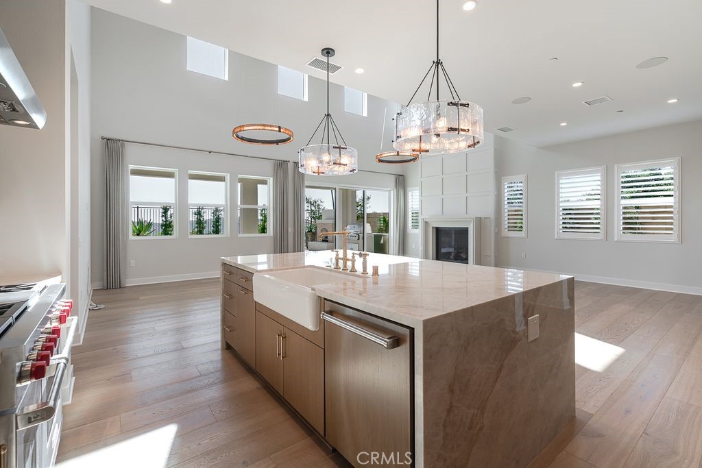 737 Via Arezzo Place Altadena, CA 91001 - Photo 9 of 25 a large kitchen with stainless steel appliances granite countertop a large kitchen island a stove and a wooden floors