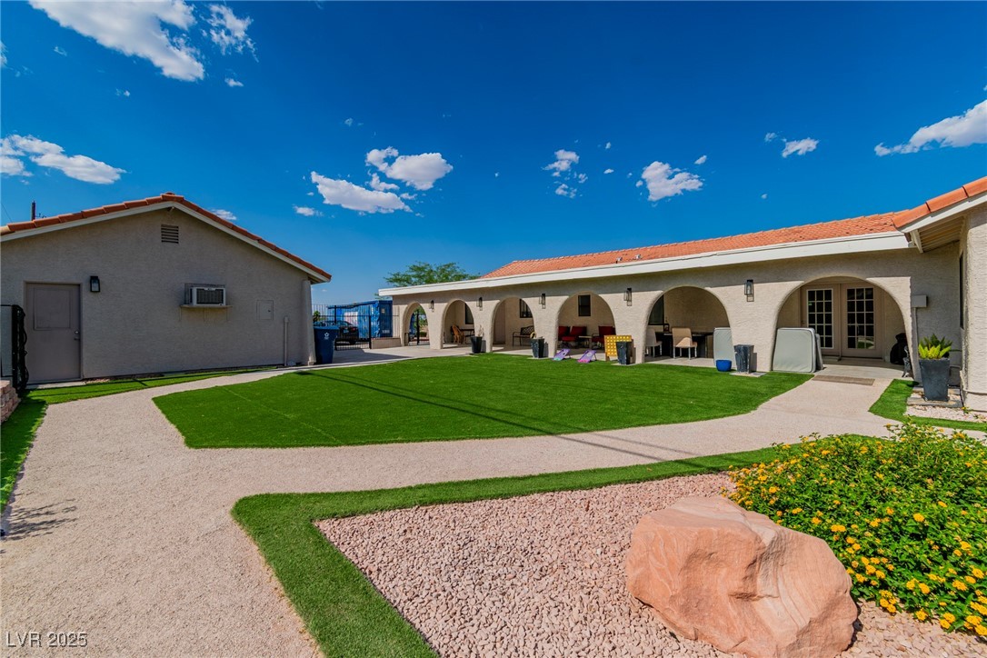 465 East Robindale Road Las Vegas, NV 89123 - Photo 14 of 32 Back of house featuring a yard, stucco siding, a p