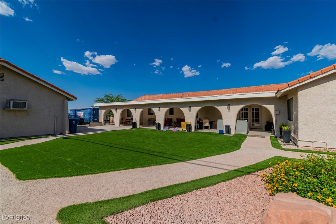 465 East Robindale Road Las Vegas, NV 89123 - Photo 15 of 32 Rear view of property with stucco siding, a lawn,