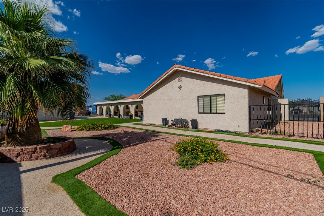 465 East Robindale Road Las Vegas, NV 89123 - Photo 17 of 32 View of home's exterior featuring a gate, stucco s