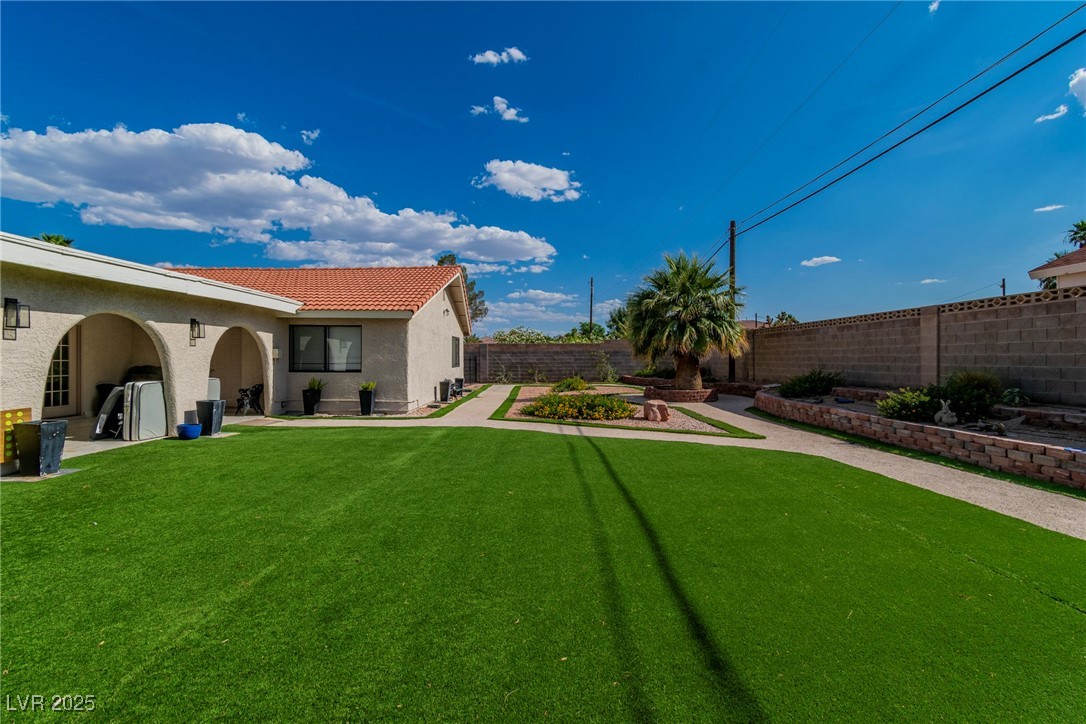 465 East Robindale Road Las Vegas, NV 89123 - Photo 18 of 32 Fenced backyard with an attached garage