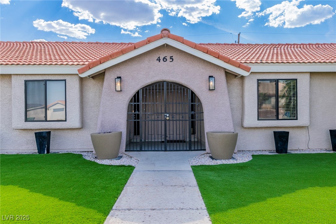 465 East Robindale Road Las Vegas, NV 89123 - Photo 2 of 32 Entrance to property featuring stucco siding, a ti