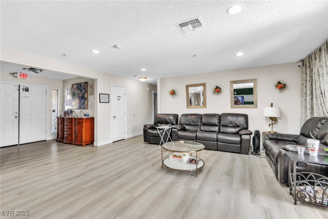 465 East Robindale Road Las Vegas, NV 89123 - Photo 24 of 32 Living area featuring a textured ceiling, wood fin