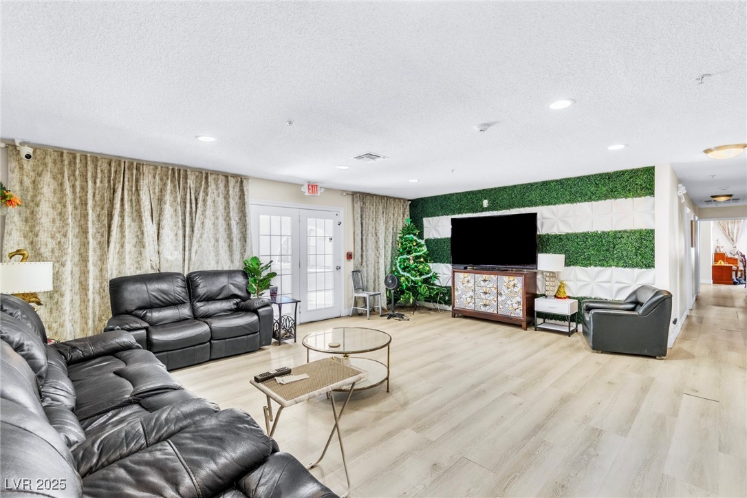 465 East Robindale Road Las Vegas, NV 89123 - Photo 26 of 32 Living room featuring a textured ceiling, light wo